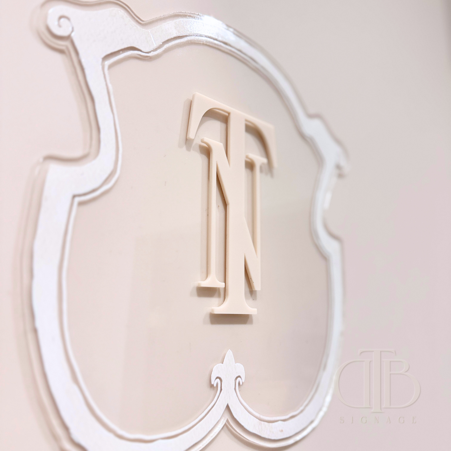 Luxury crest in Beige frame UV printed on clear acrylic, close up view of acrylic initials