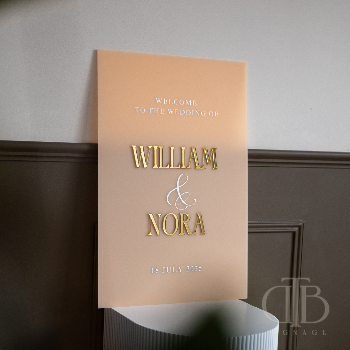Wedding welcome sign with 'William & Nora' on a beige background