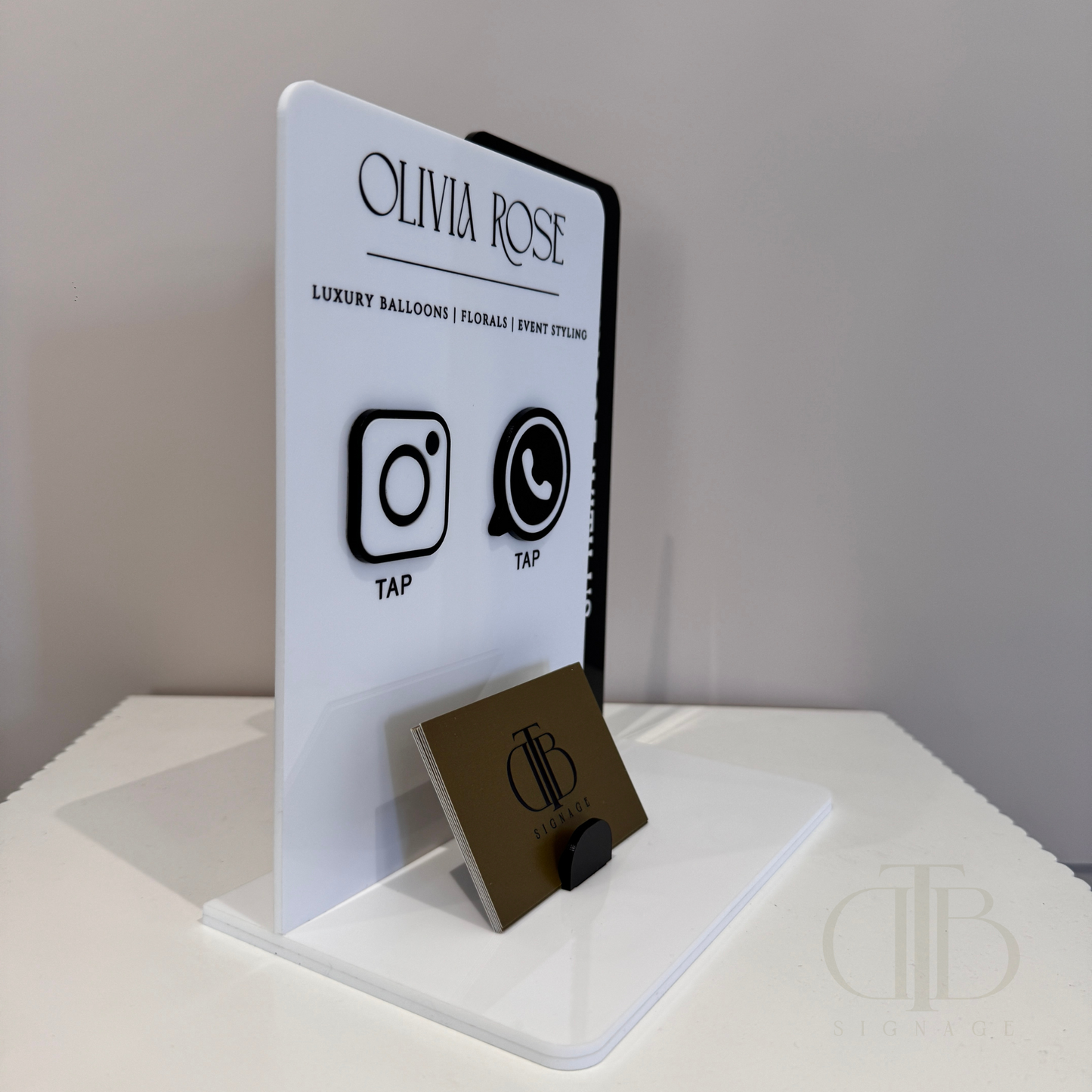 Side view of Customisable acrylic Social Media Board with Whatsapp and Instagram icons with NFC tap technology on a white surface, also have a slot of holding Business Cards, fully made of premium acrylics.