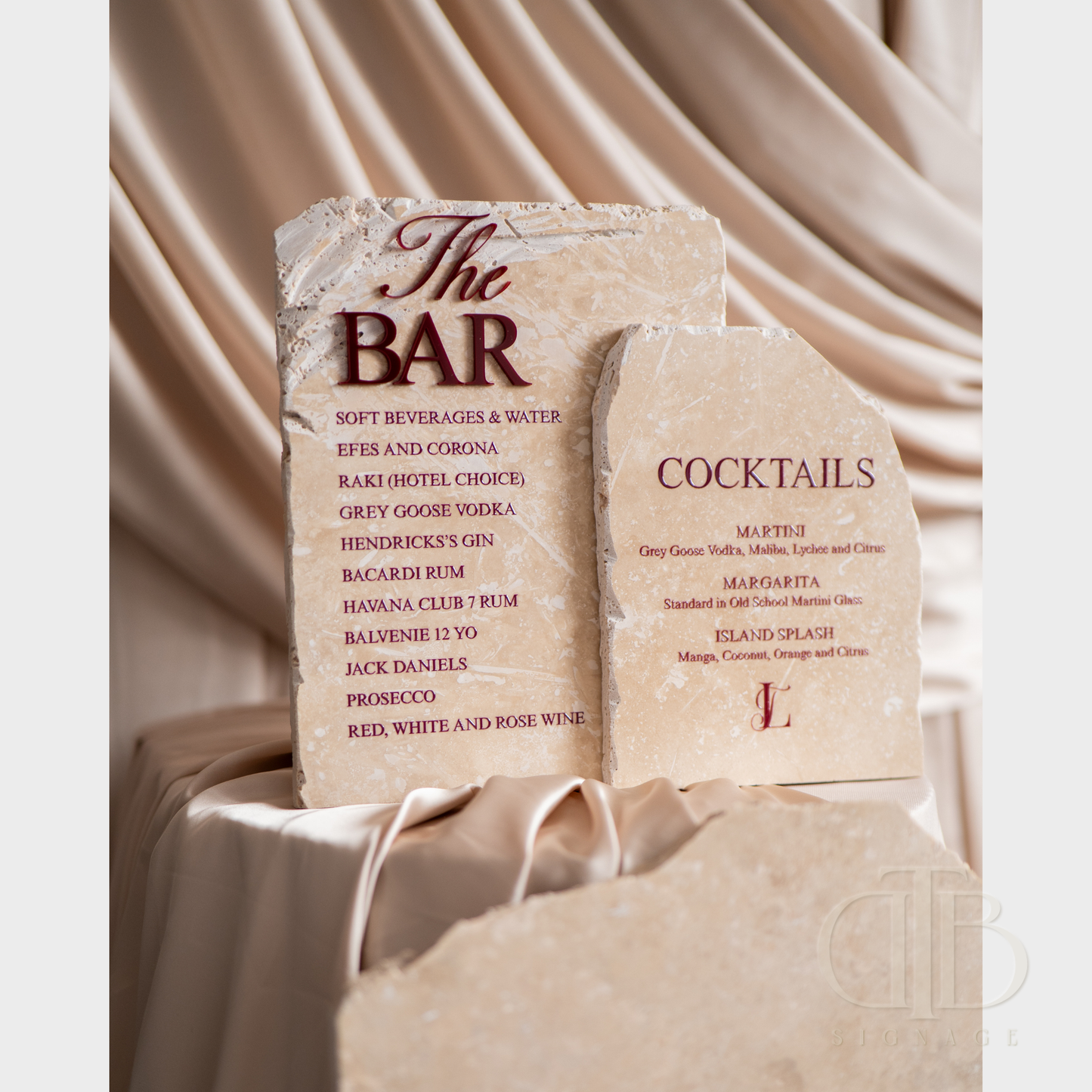 Stone bar menu with drinks list on a draped fabric background