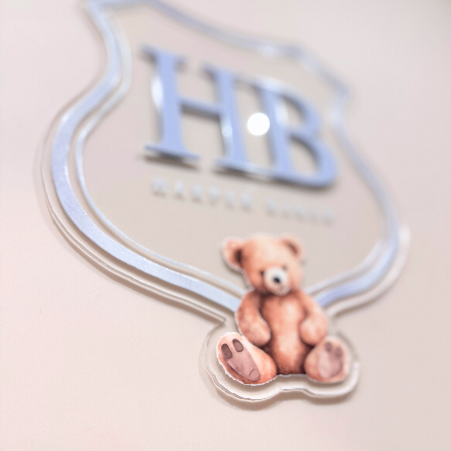 Luxury crest with HB initials, teddy bear UV printed, close up view