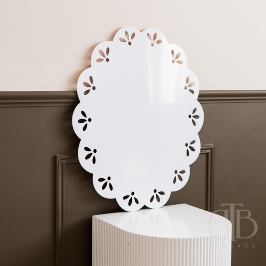 Decorative white doily on a pedestal against a neutral wall