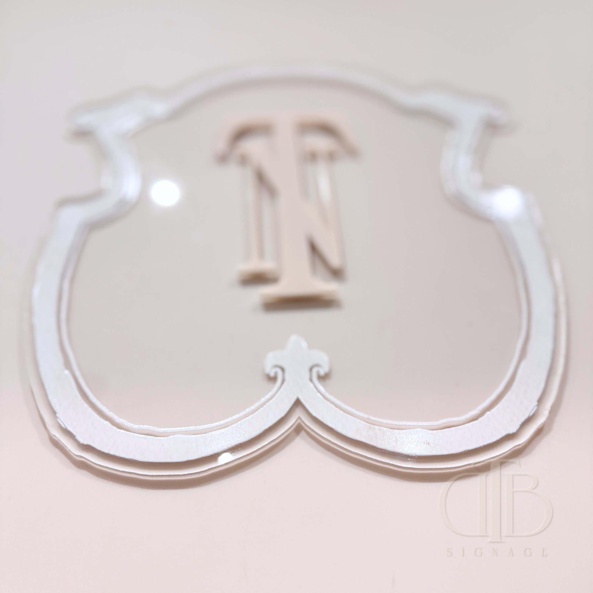 Luxury crest in Beige frame UV printed on clear acrylic, close up view
