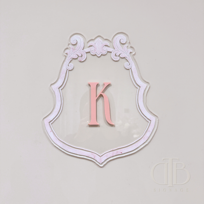 Luxury crest with baby pink frame UV printed and acrylic initial K in baby pint, front view
