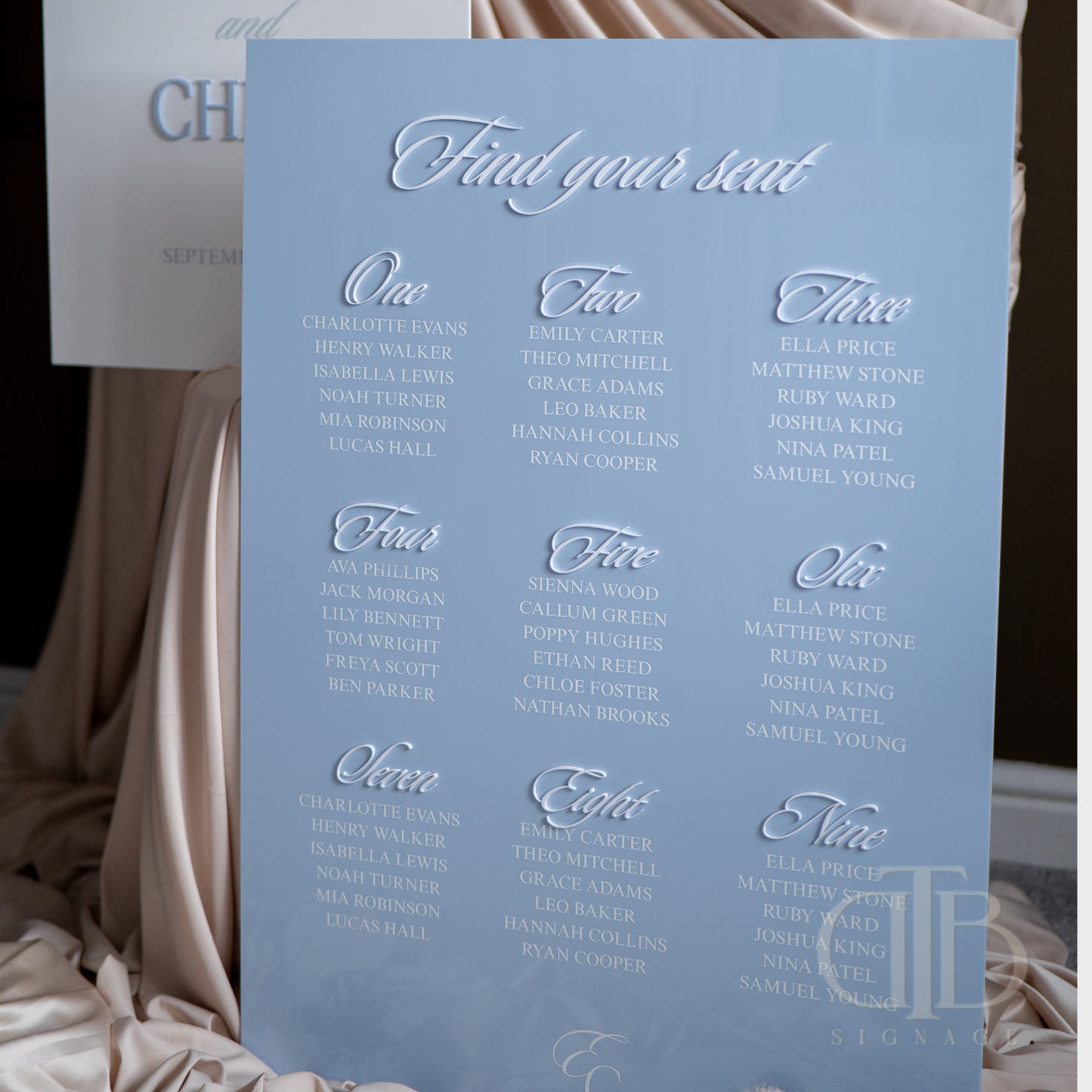 Blue seating chart with white text on a blurred background