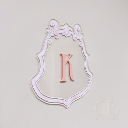 Luxury crest with baby pink frame UV printed and acrylic initial K in baby pint, left side view