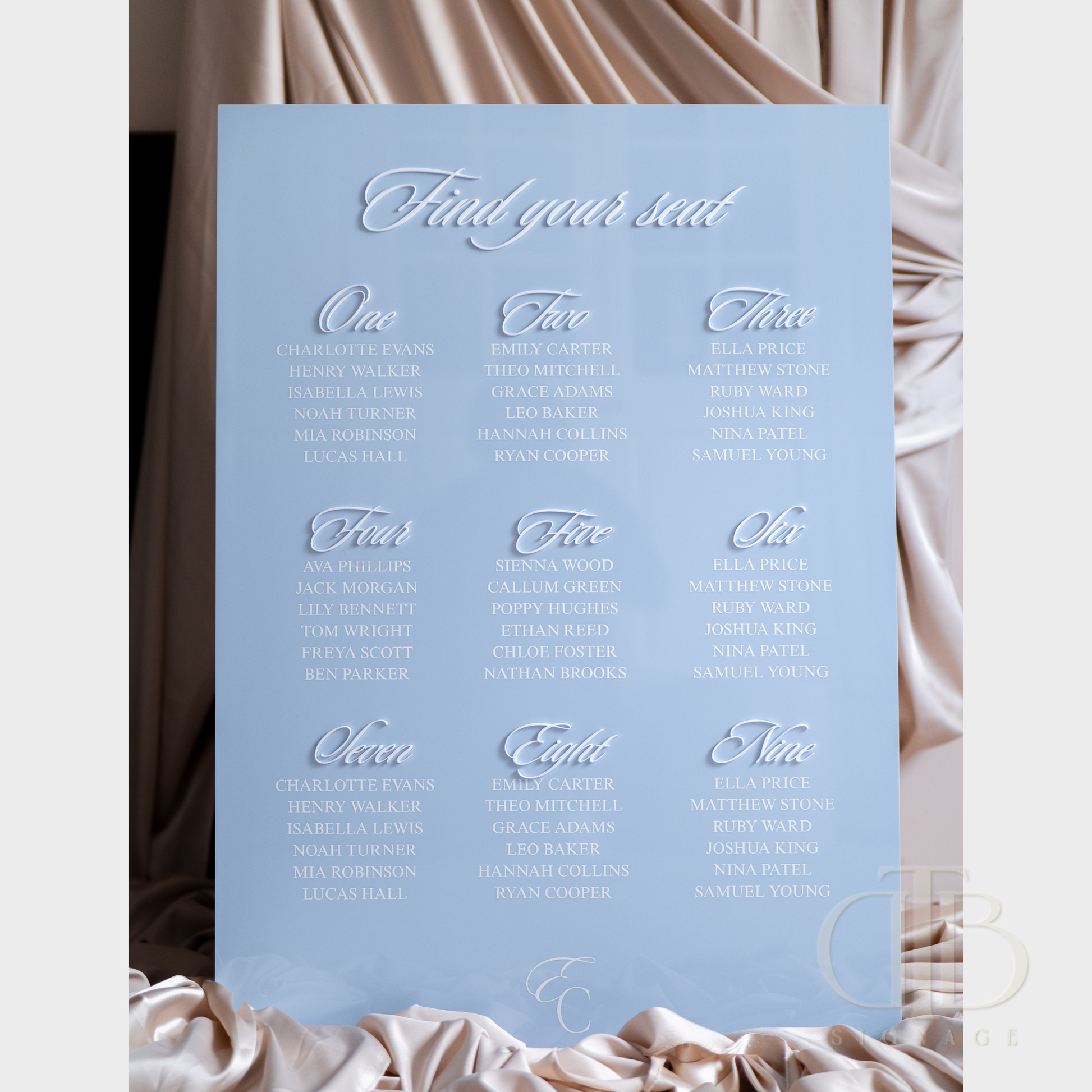 Light blue seating chart with white text on a draped fabric background
