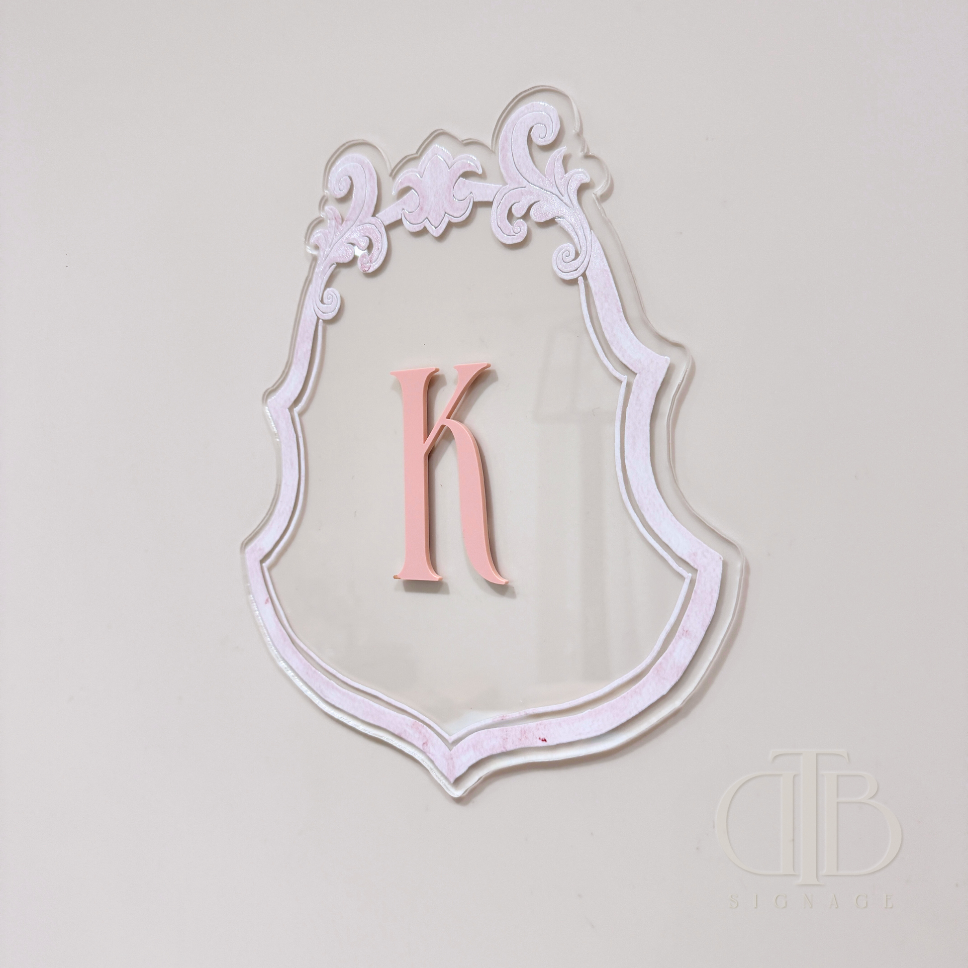 Luxury crest with baby pink frame UV printed and acrylic initial K in baby pint, right side view