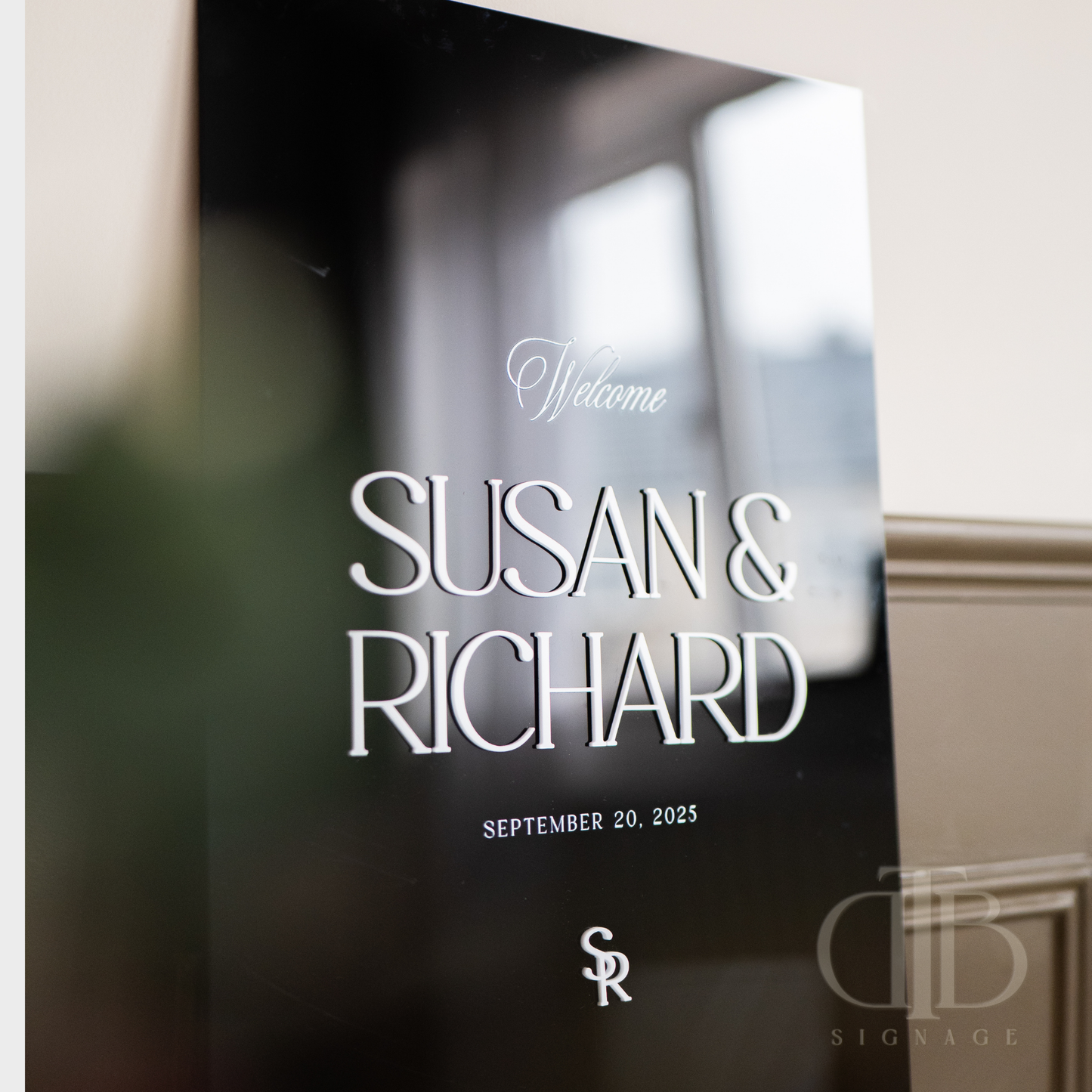 Decorative glass door with 'Welcome Susan & Richard' text and date, featuring a logo.