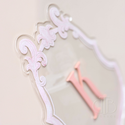 Luxury crest with baby pink frame UV printed and acrylic initial K in baby pint, close up view of the frame showing raised effect of the UV print