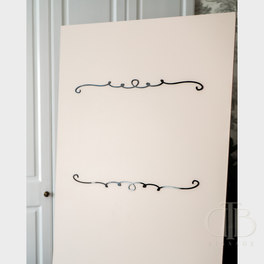 White board with decorative black text on a white wall