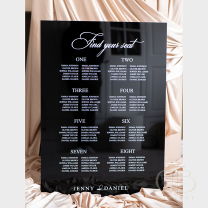 Black seating chart with white text on a decorative background