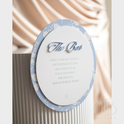 Decorative drink menu with blue and white design on a neutral background