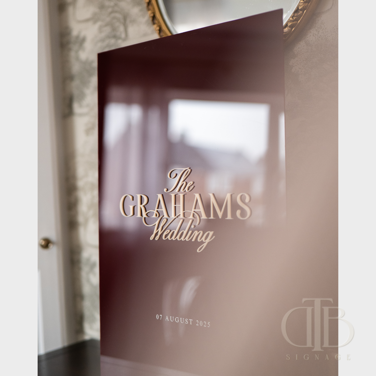 Invitation card with 'The Grahams Wedding' text and date, featuring a blurred background.