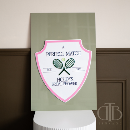 Decorative sign for a bridal shower with tennis racket design on a green background