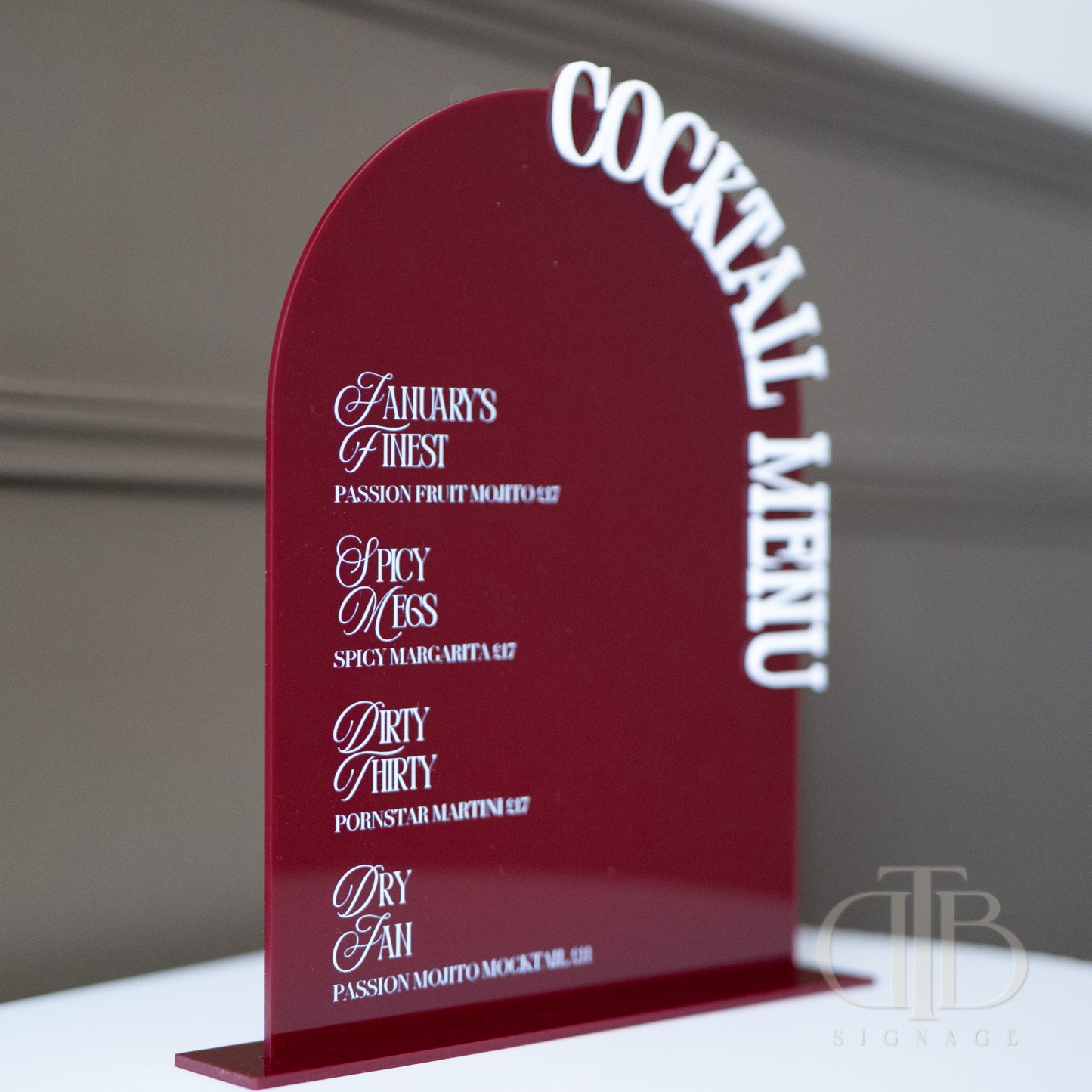 Red cocktail menu with white text on a gray background