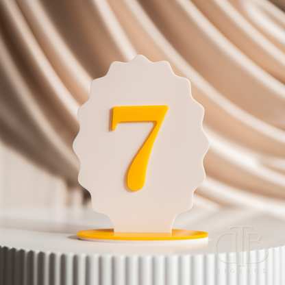 White and yellow number '7' against a beige curtain background
