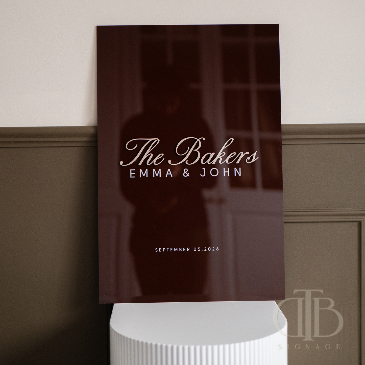 Personalized wall art with 'The Bakers Emma & John' text on a dark background