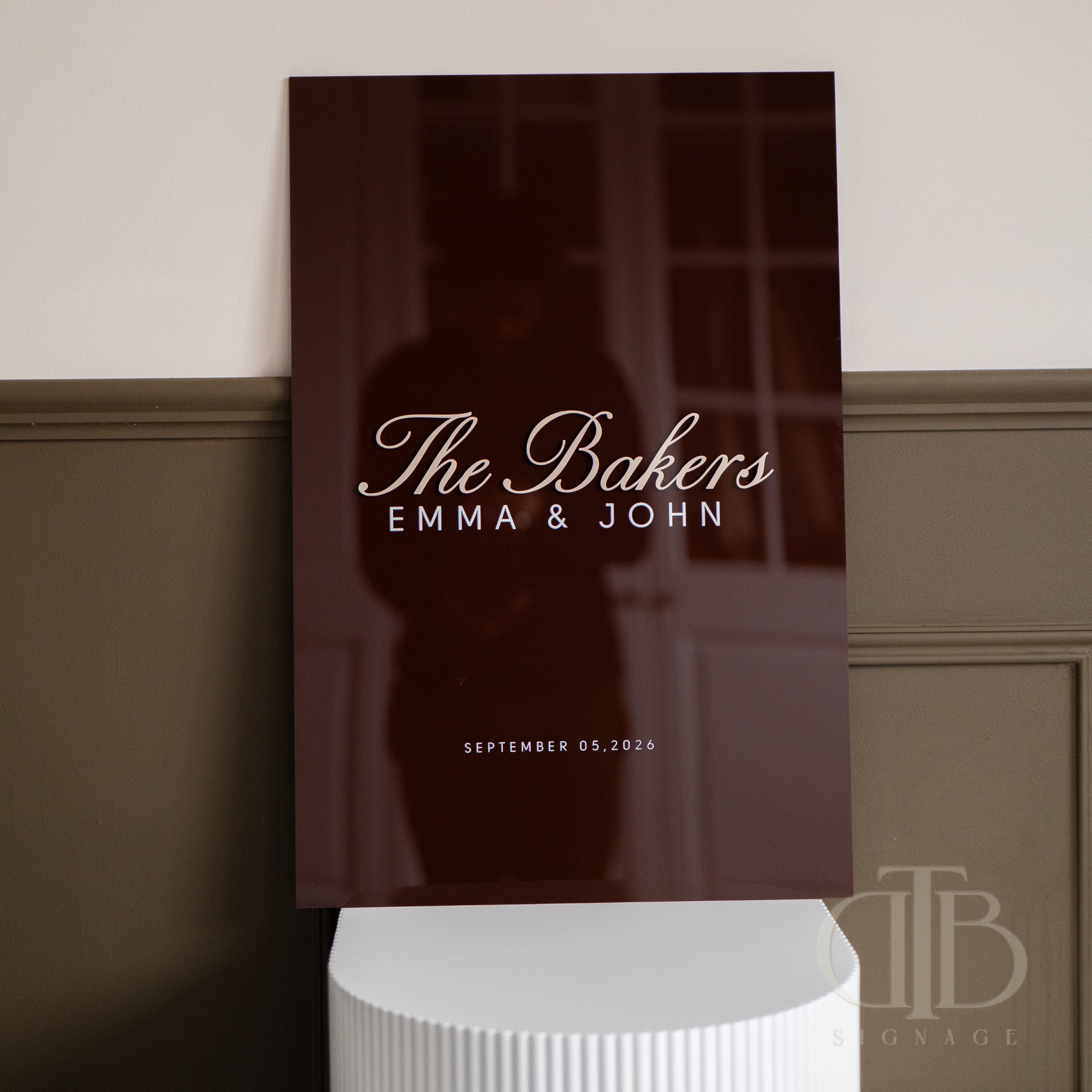 Personalized wall art with 'The Bakers Emma & John' text on a dark background