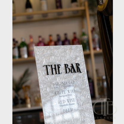 Menu for 'The Bar' with wine and beer options on a blurred bar background