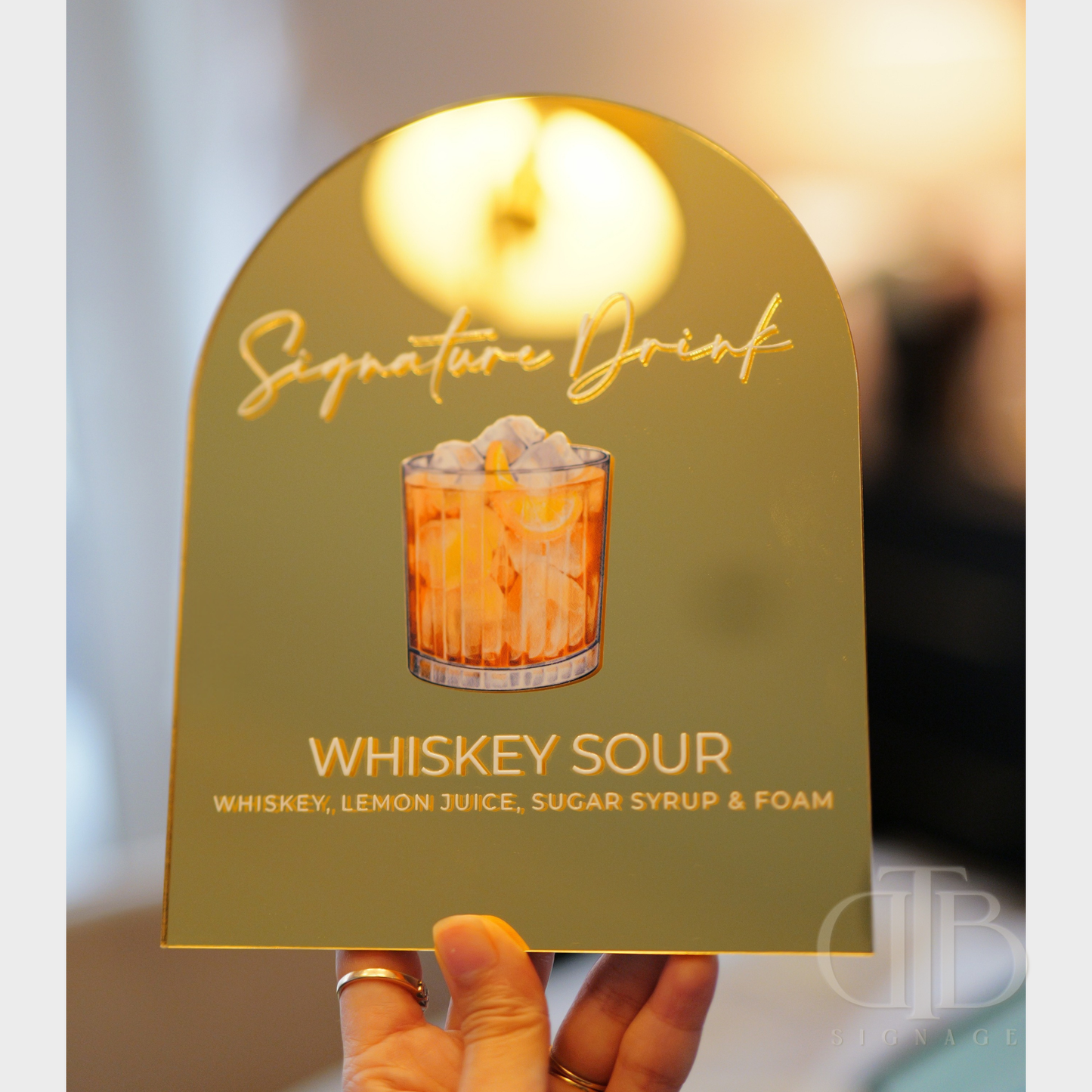 Sign with illustration of a whiskey sour and description on a blurred background