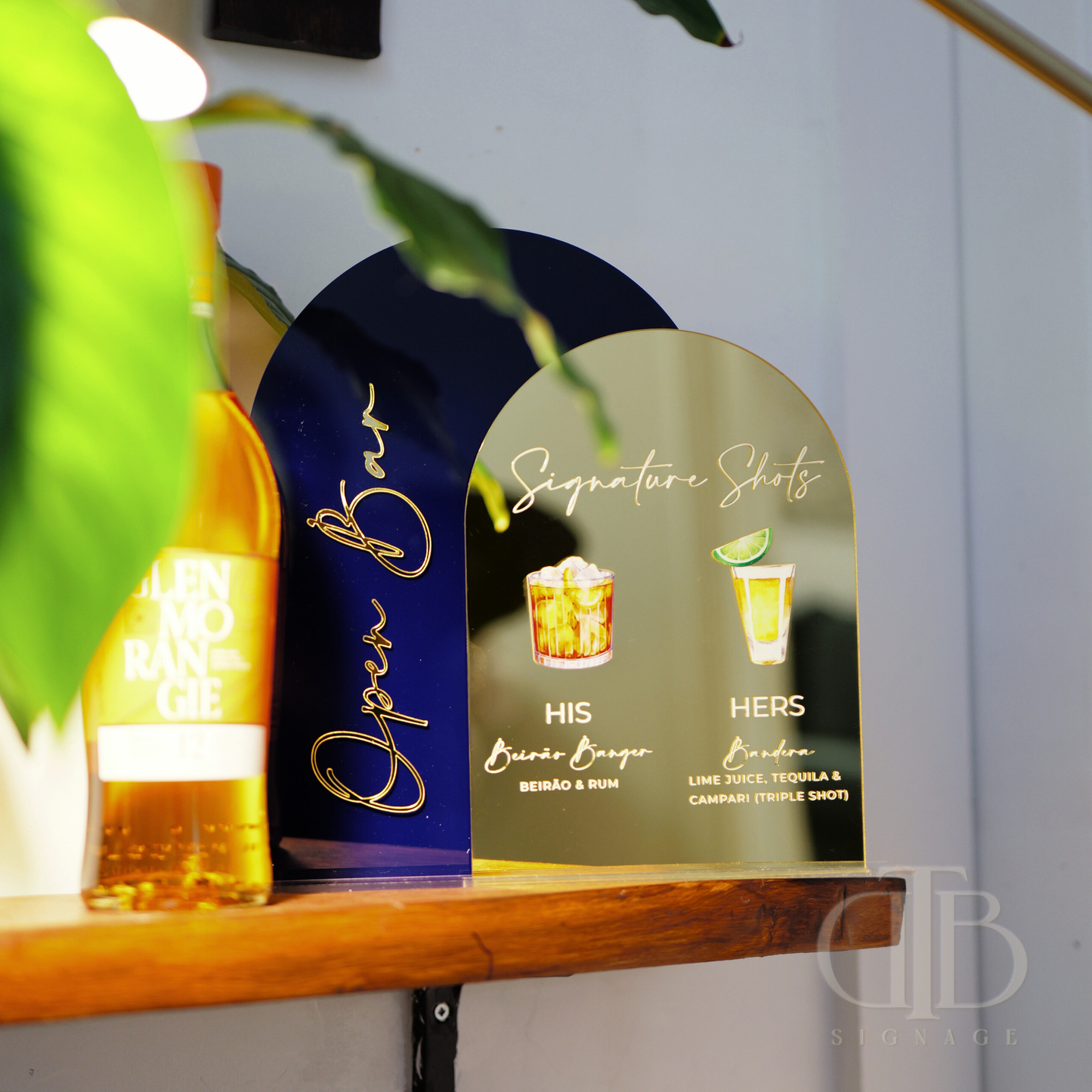 Bottle of Jose Cuervo and a decorative sign for 'Open Bar' on a shelf.