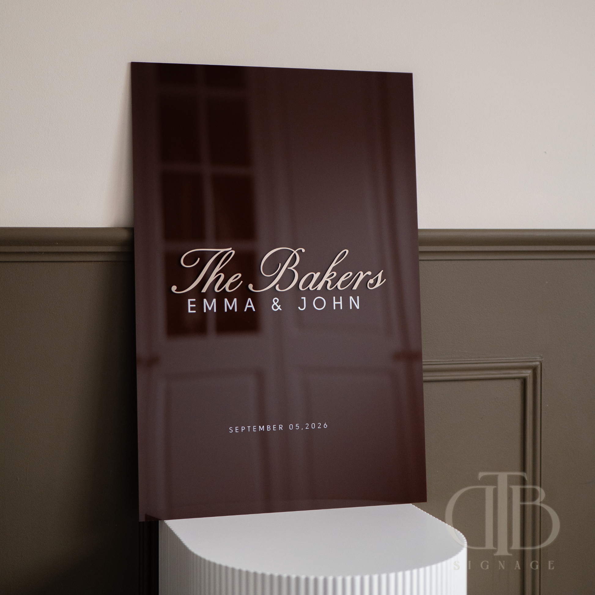 Brown paper bag with 'The Bakers Emma & John' text on a neutral background