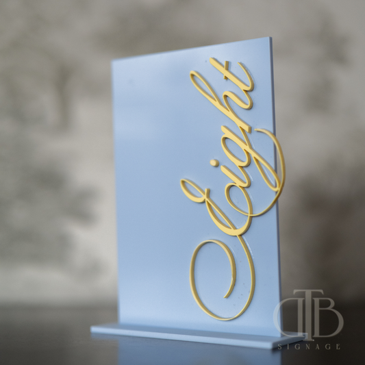 Light blue sign with gold 'Eight' text on a blurred background