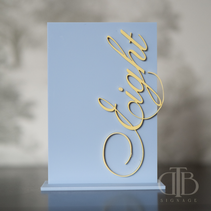 Gold 'Eight' sign on a blue stand with a blurred background