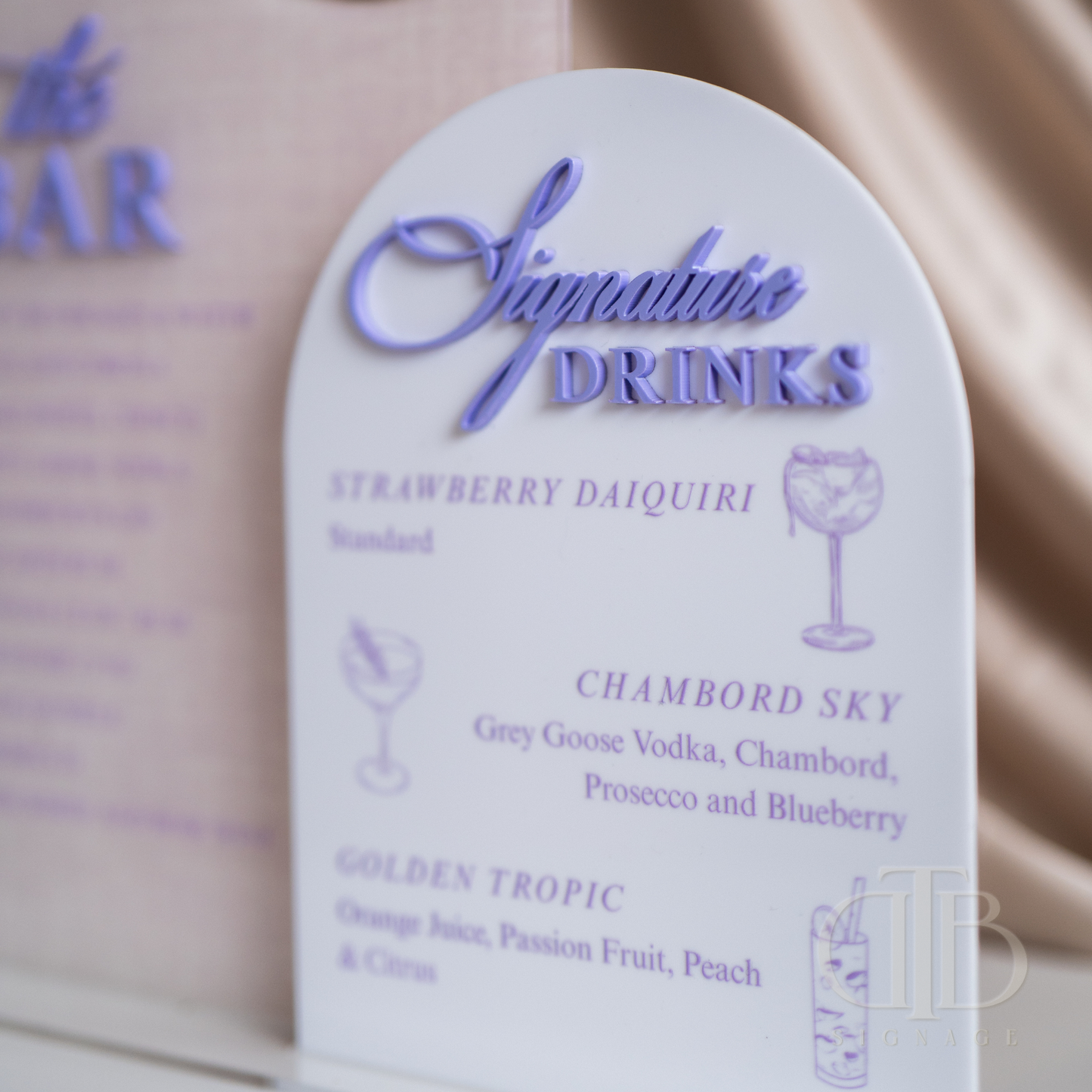 Menu card for Signature Drinks with strawberry daiquiri and other cocktail options on a beige background.