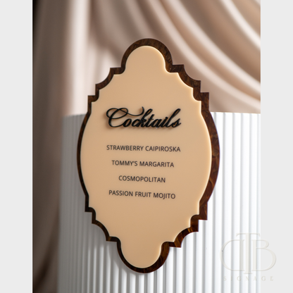 Decorative cocktail menu with wooden frame against a draped fabric background
