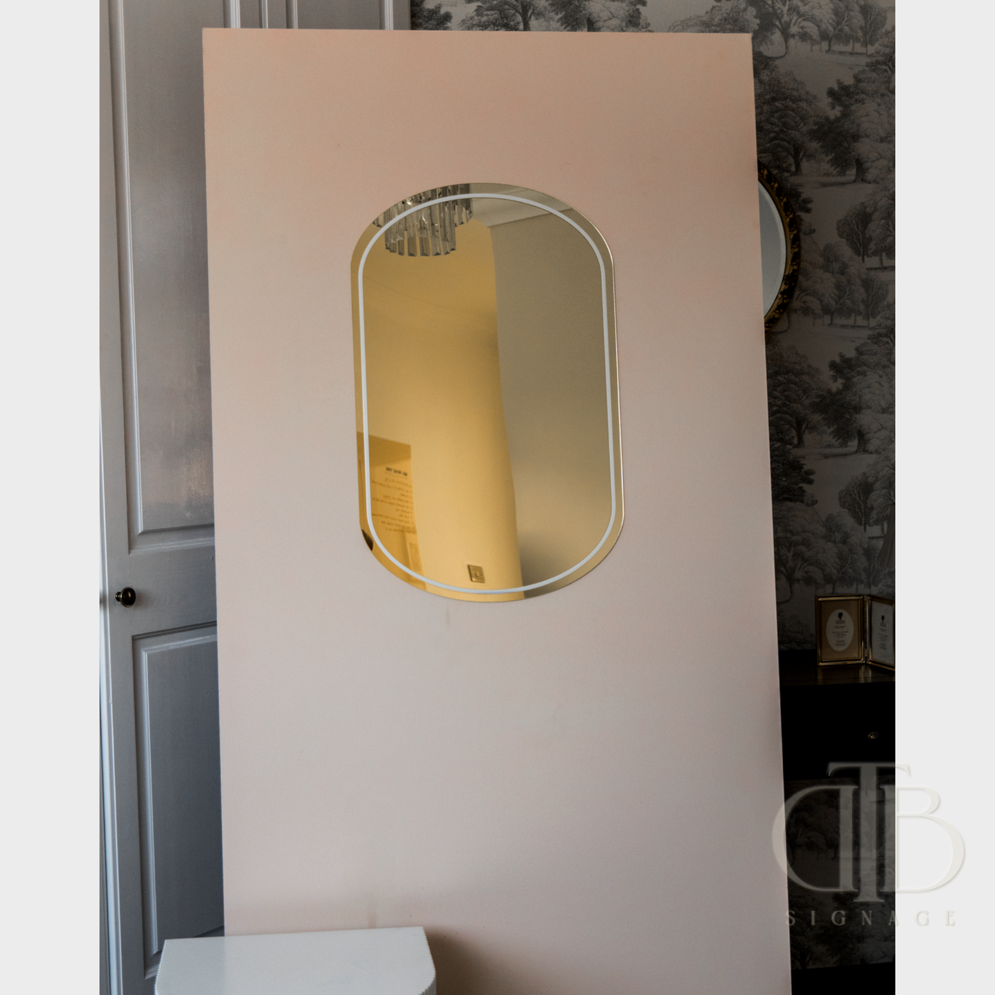 Rectangular mirror on a white wall with a dark textured background