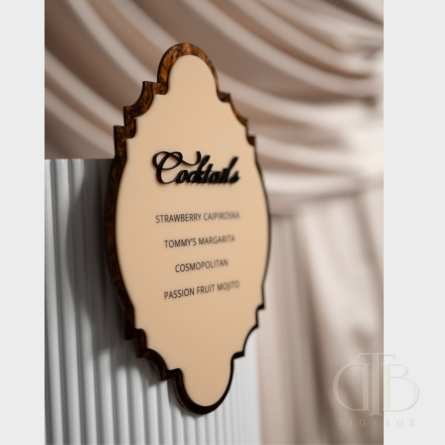 Wooden menu with cocktail names against a textured wall