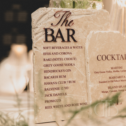 Stone sign with bar menu and drink list on a blurred background