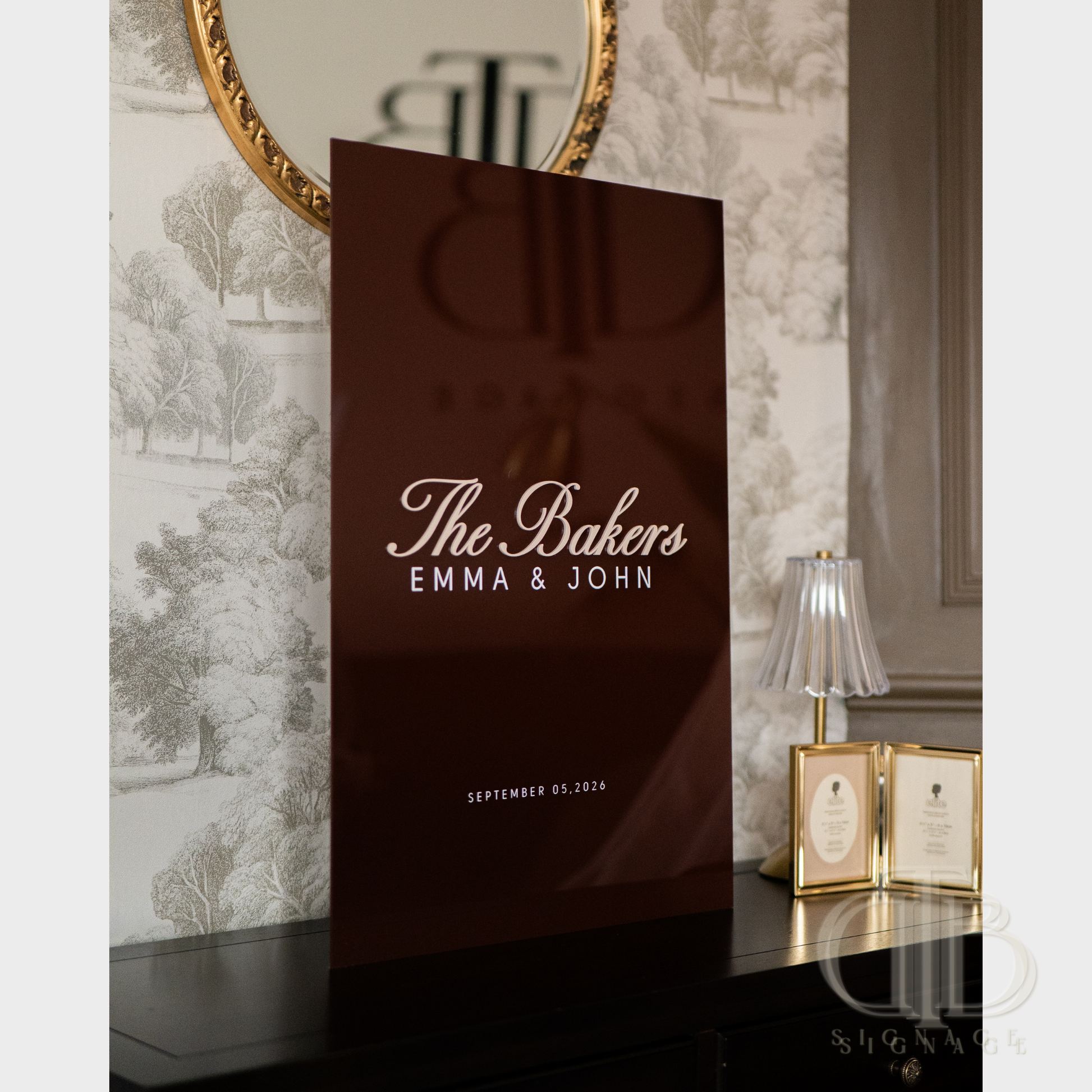 Personalized brown paper bag with 'The Bakers Emma & John' text on a decorative wall background.