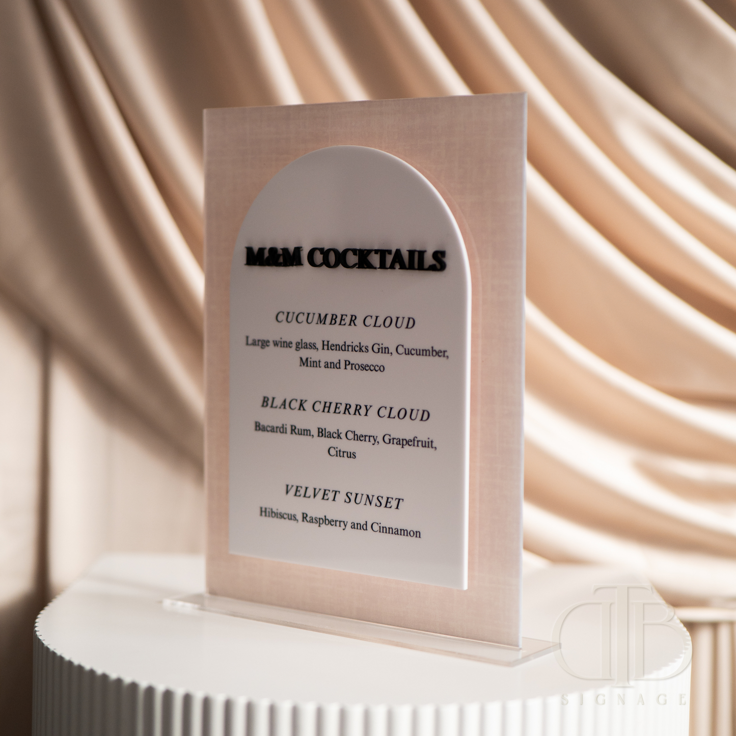 Cocktail menu on a stand with a beige curtain background