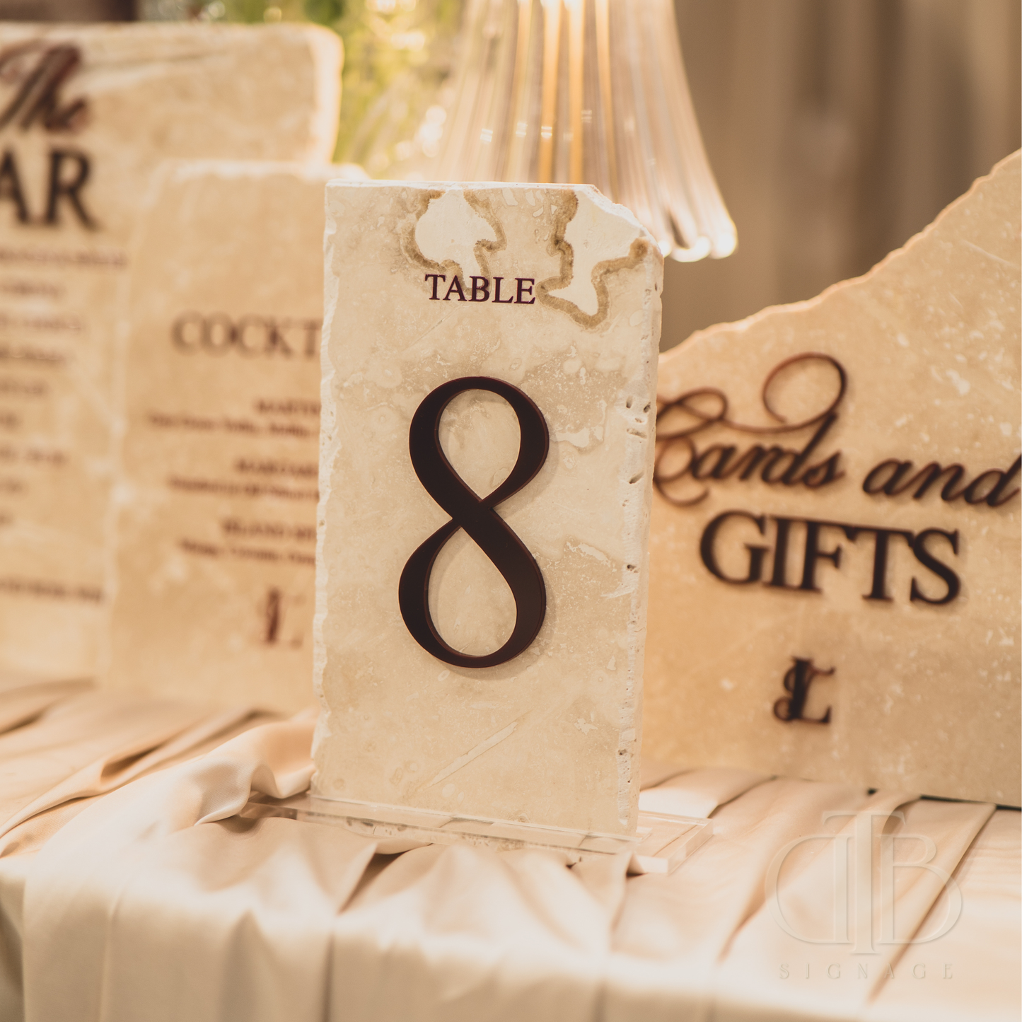 Table number 8 on a decorative card with 'Cards and Gifts' text, set against a blurred background.