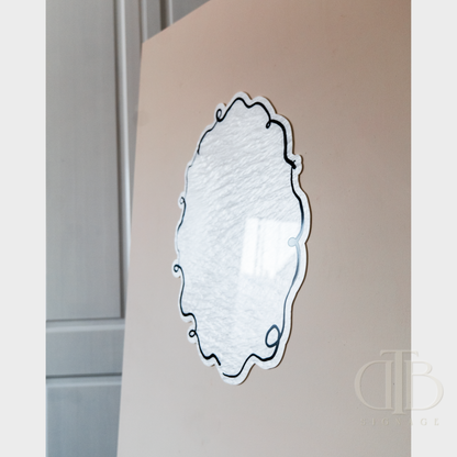 Decorative wall mirror with intricate design on a neutral background