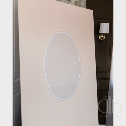 Beige wall with circular cutout and light fixture in the background