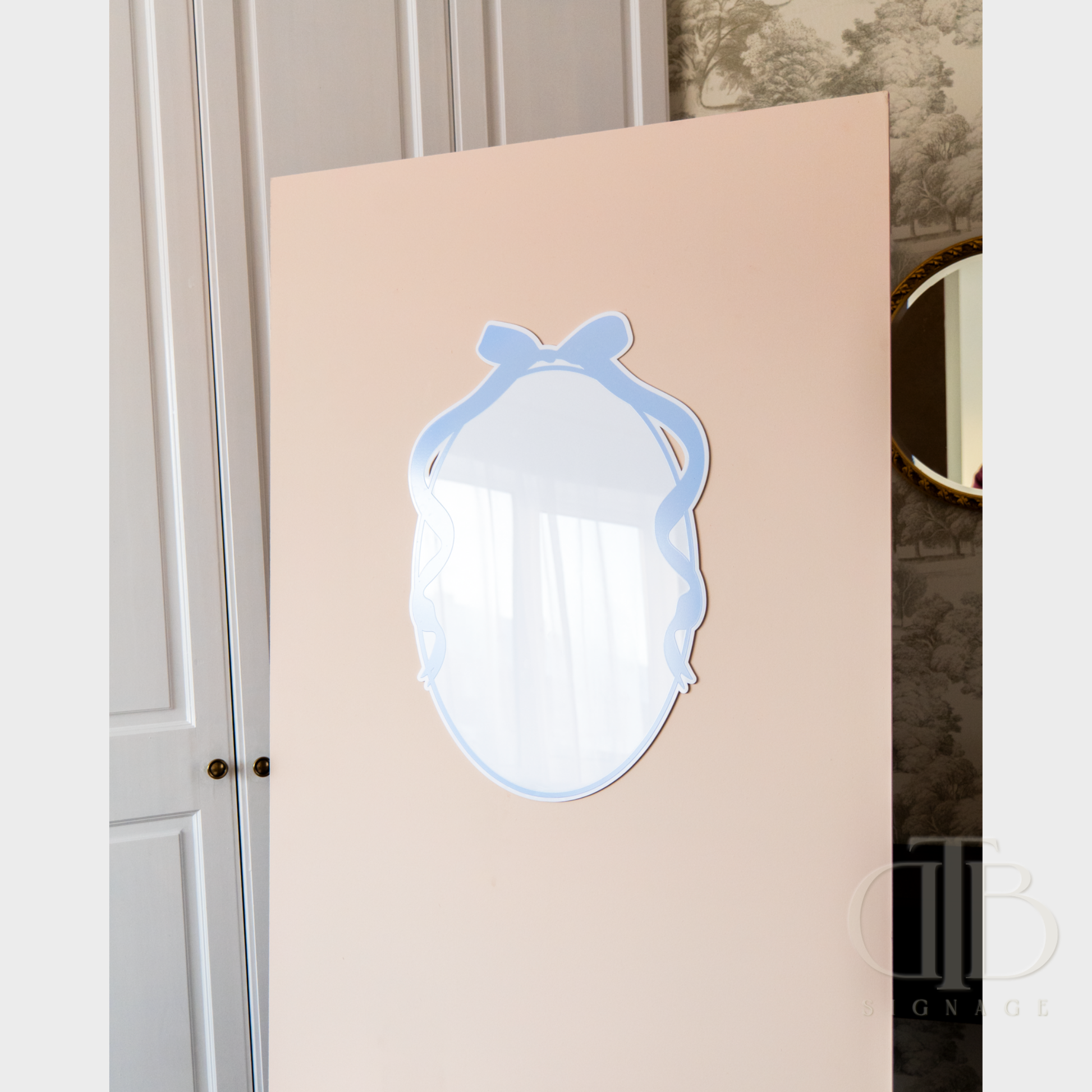 Decorative mirror with a blue frame on a beige background