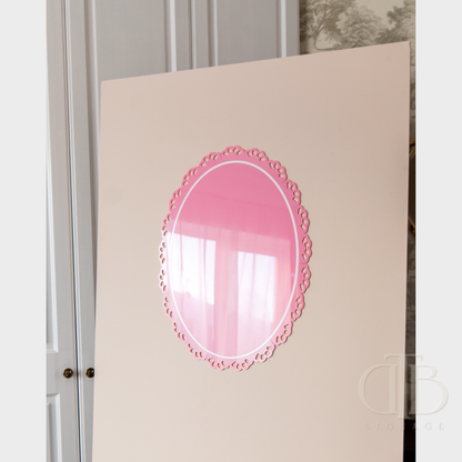 Pink decorative acrylic signage on a white wall