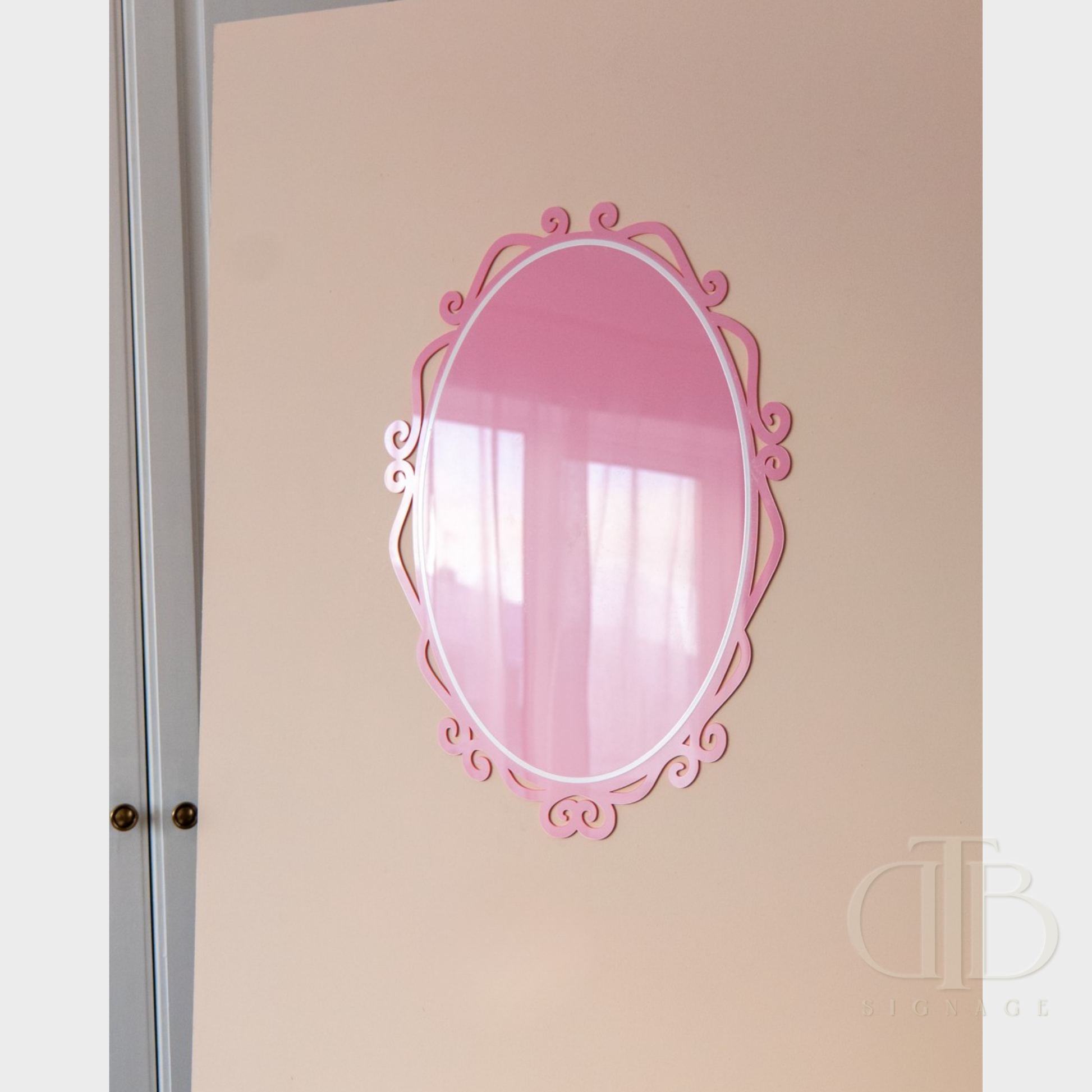 Decorative pink acrylic signage on a beige wall
