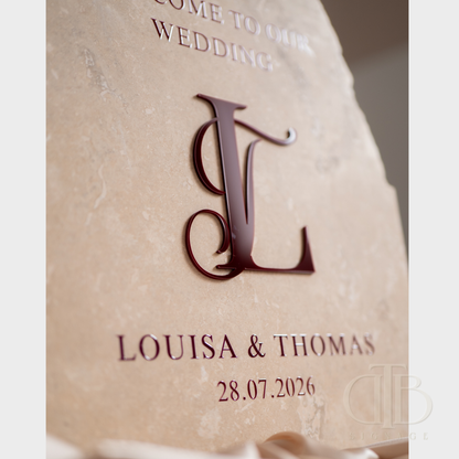 Wedding invitation card with monogram 'LJ' and personalized details on a textured beige background