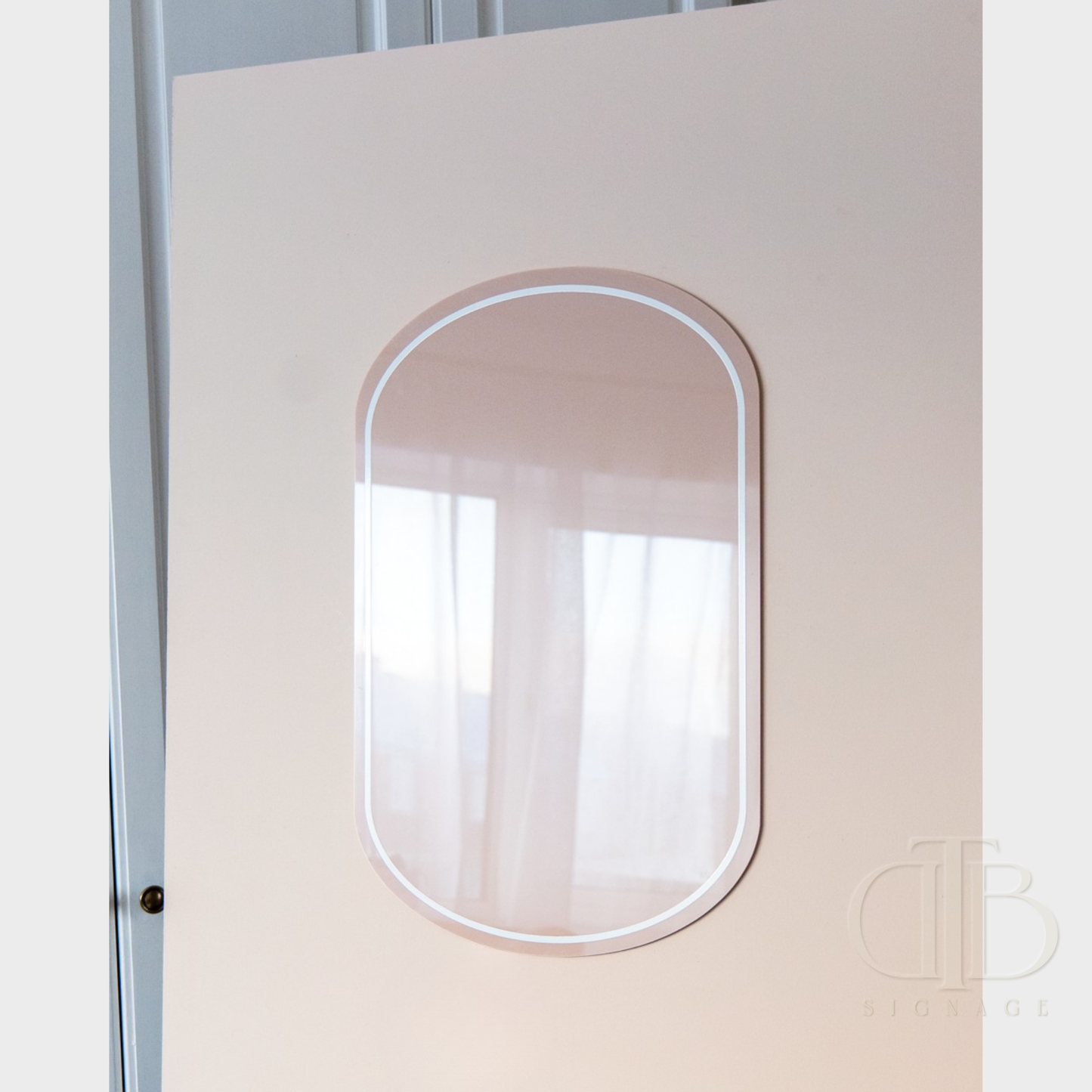 Decorative acrylic signage with a beige frame on a white wall