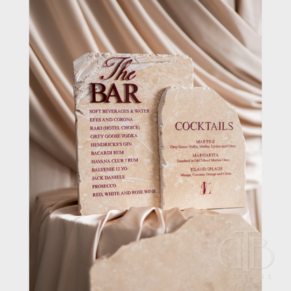 Stone bar menu with drinks list on a draped fabric background