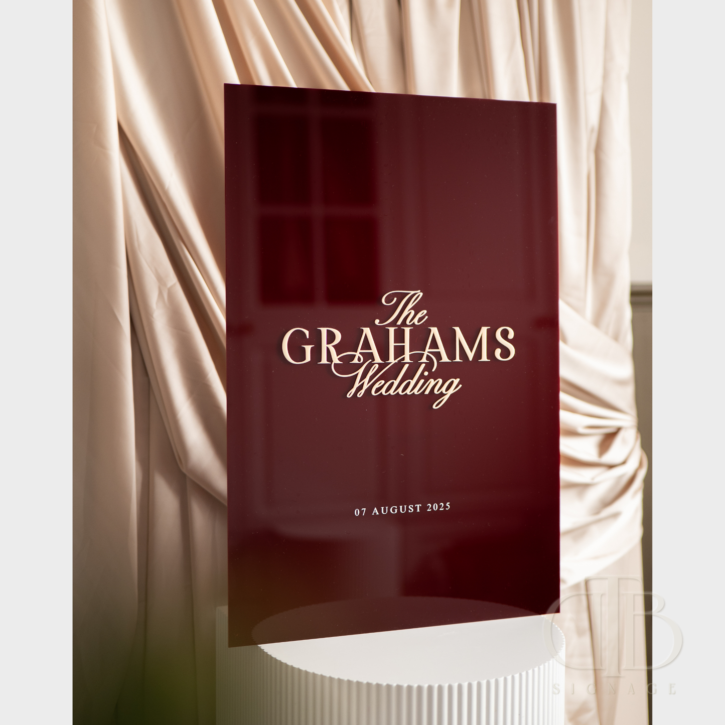 Maroon program with 'The Grahams Wedding' text on a draped curtain background