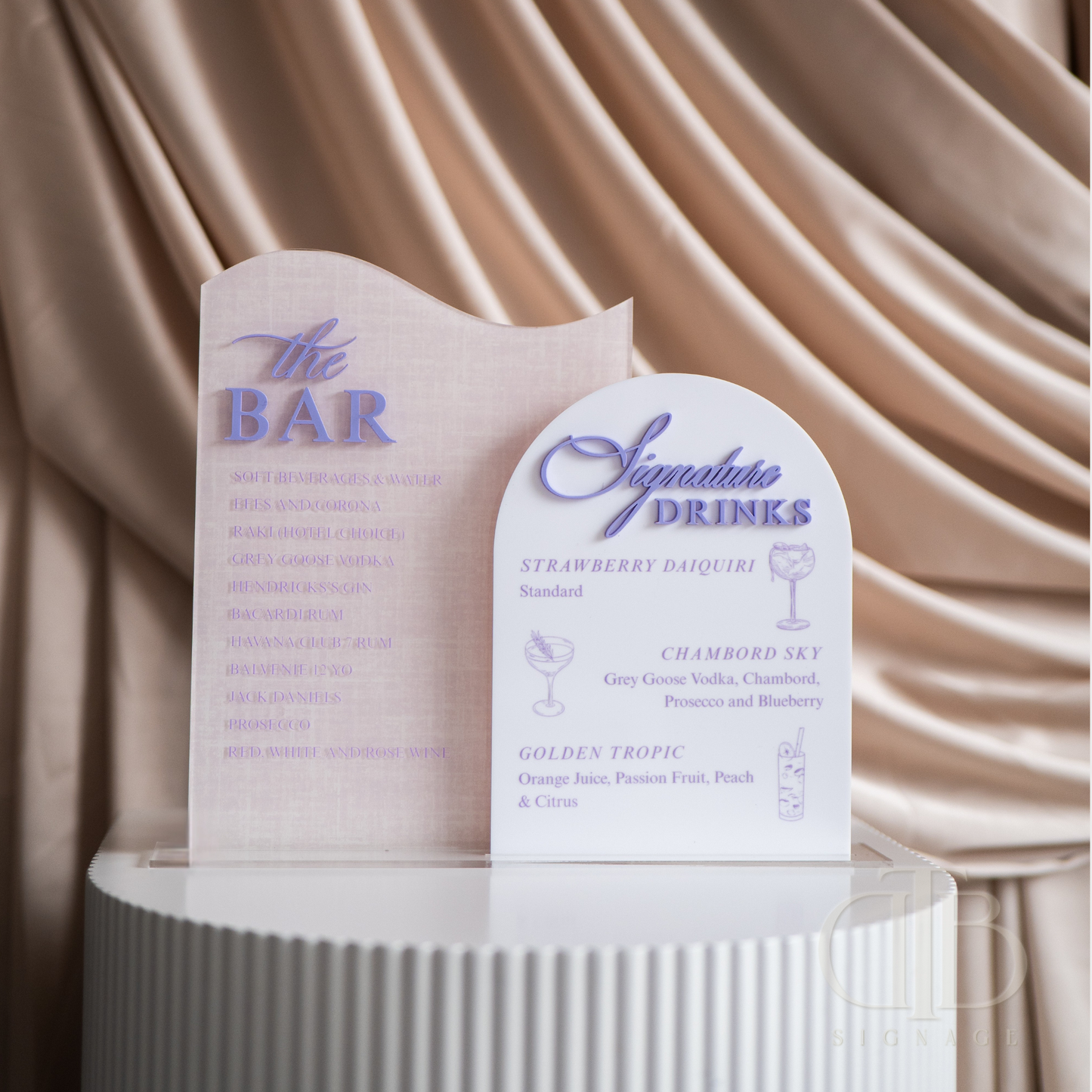 Two menu boards for 'The Bar' and 'Signature Drinks' against a beige curtain background.