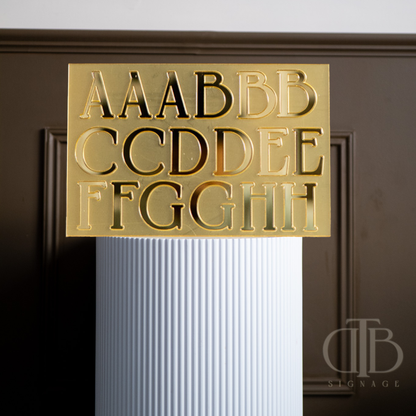 Gold lettering on a white column with a dark background