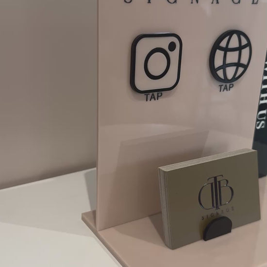 Video clip of Customisable Social Media Board with Whatsapp and Instagram icons with NFC tap technology on a white surface, also have a slot of holding Business Cards, fully made of premium acrylics. Consists o double acrylic board style.