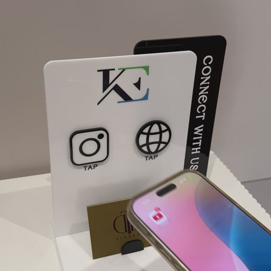 Video demonstration of a Customisable Social Media Board with Whatsapp and Instagram icons with NFC tap technology on a white surface, also have a slot of holding Business Cards, fully made of premium acrylics. 